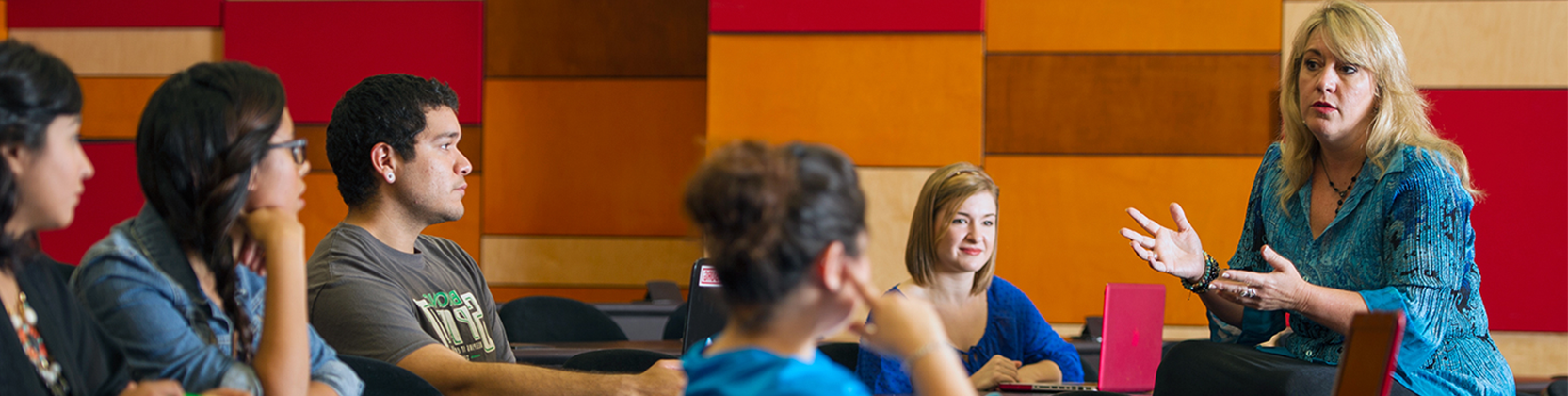 Faculty having a class discussion with students. 